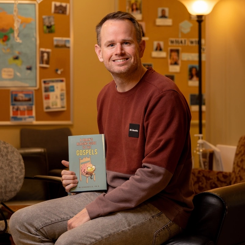 Dr. Tim Schoenfeld with his book, "A Brain's Reading Guide to the Gospels".