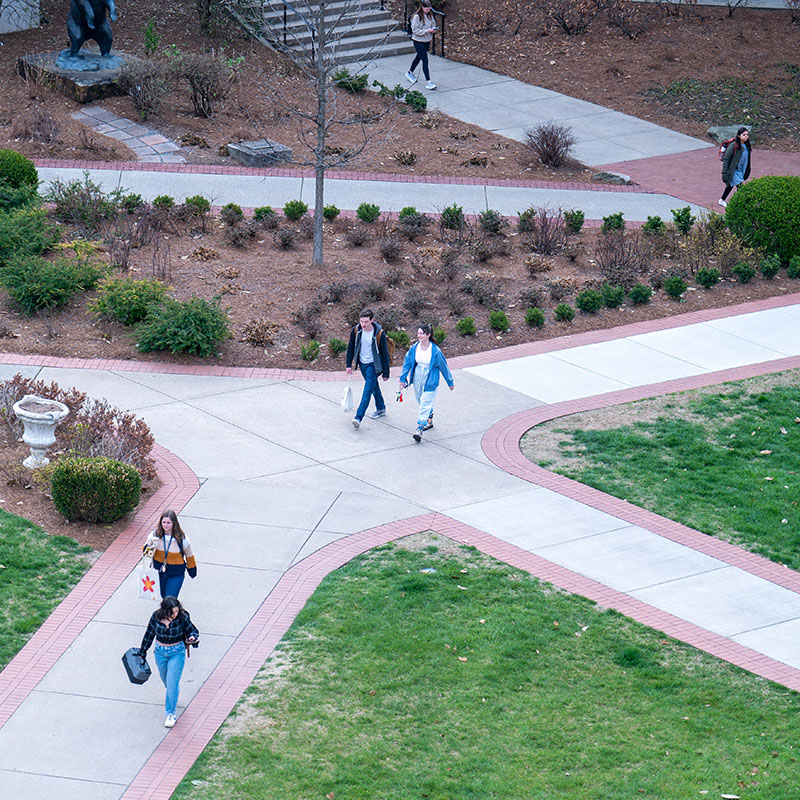 Students at a crossing of two sidewalks