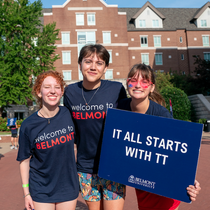 Students cheering with signs at Orientation