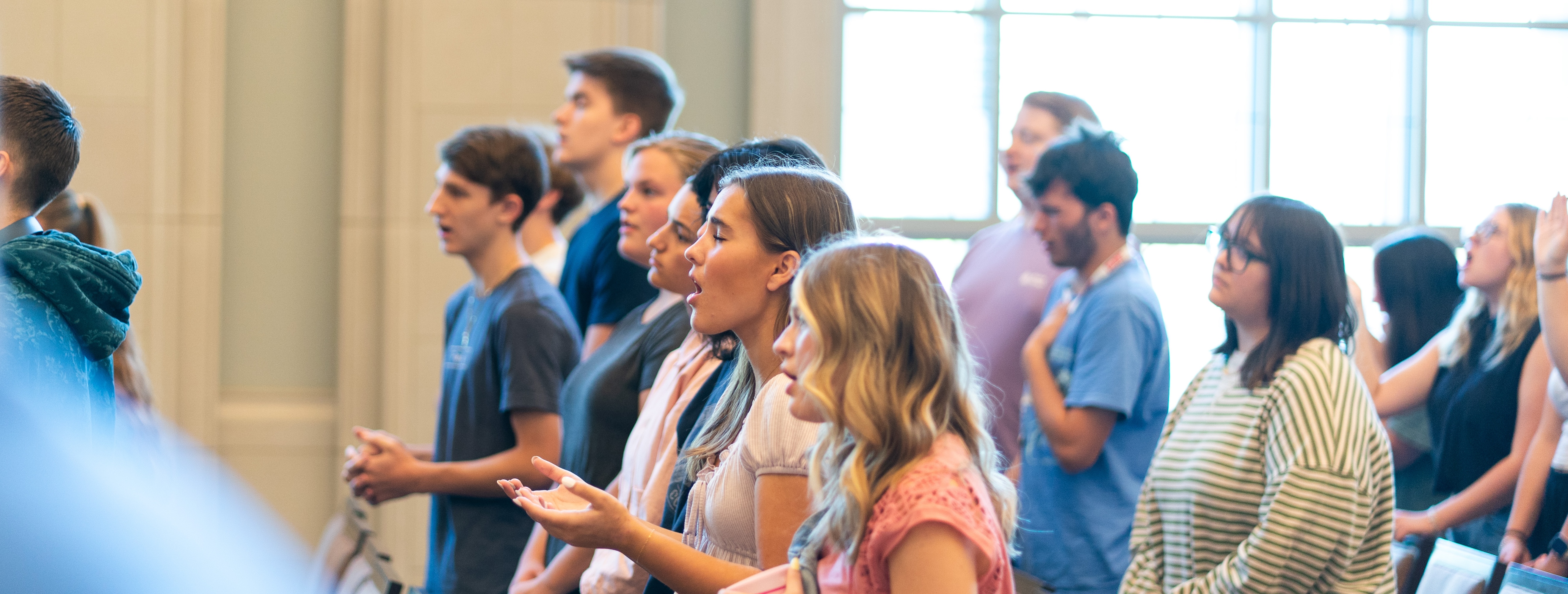 Group of students standing and worshipping in the Gabhart Chapel space