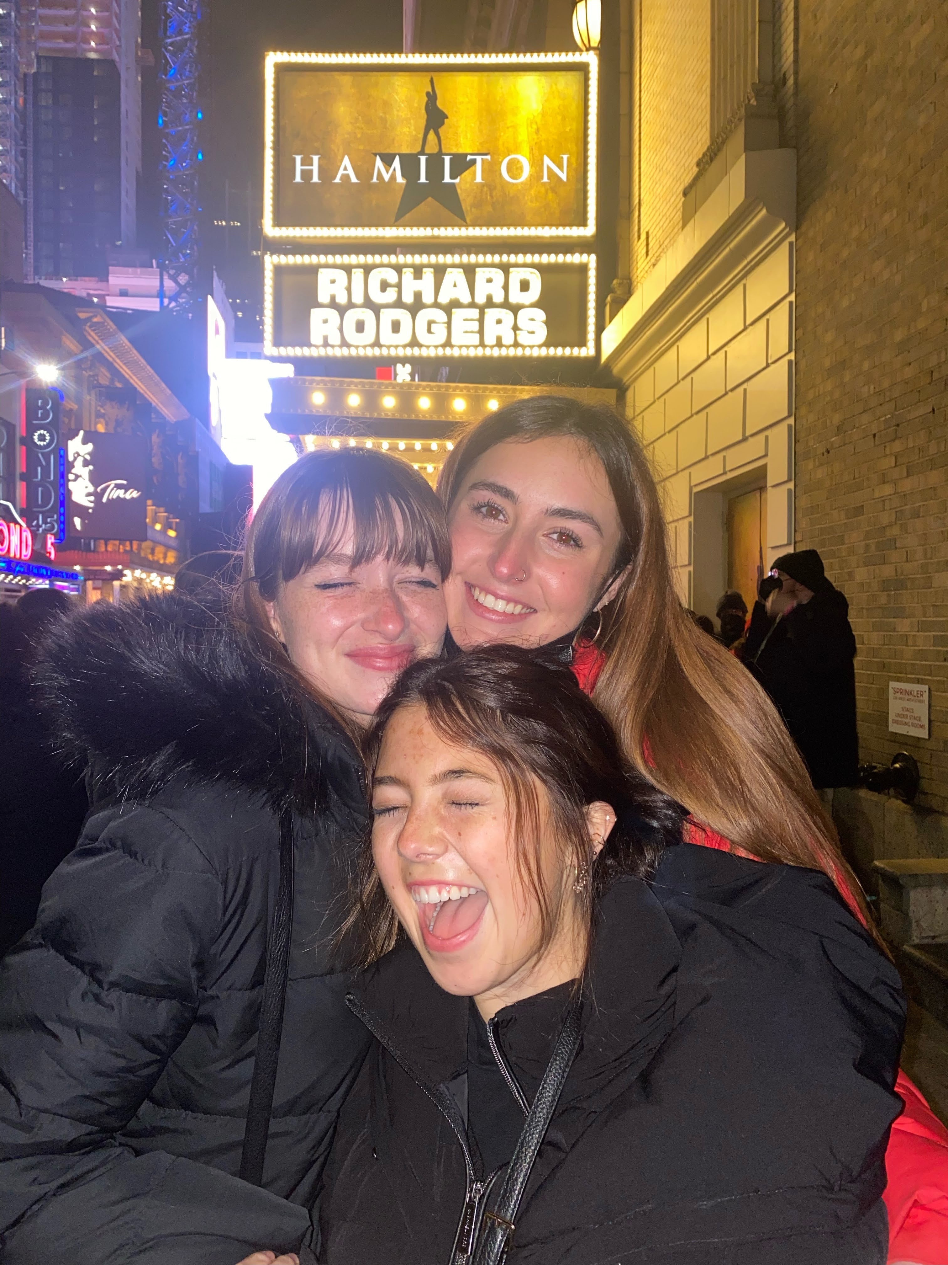Belmont East students pose in fron of Broadway show Hamilton sign