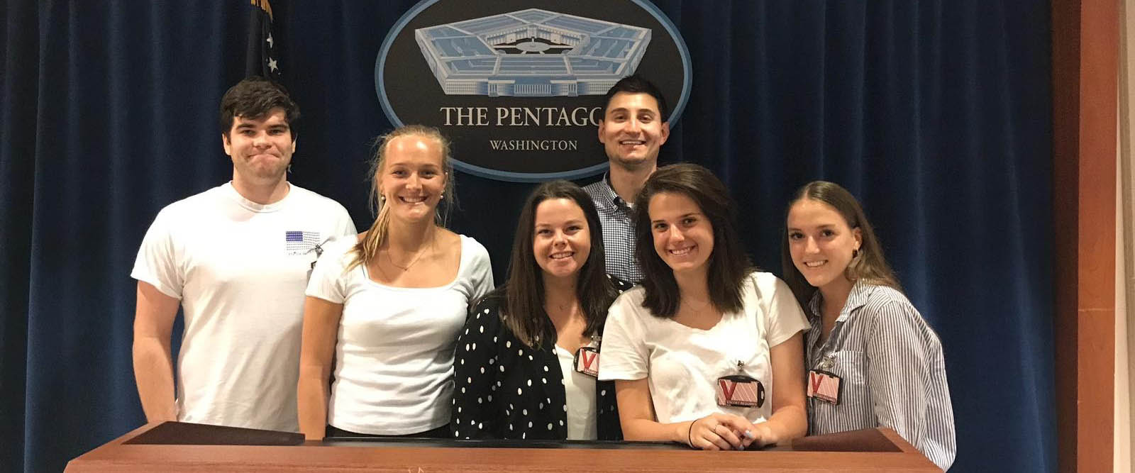 Belmont USA students pose in front of the podium at the Pentagon in Washington