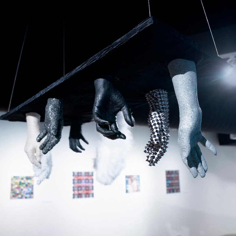 textured hands are suspended for physical engagement - art