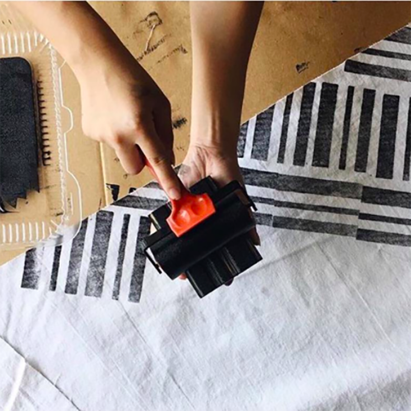 two student looking at a piece of patterned cloth