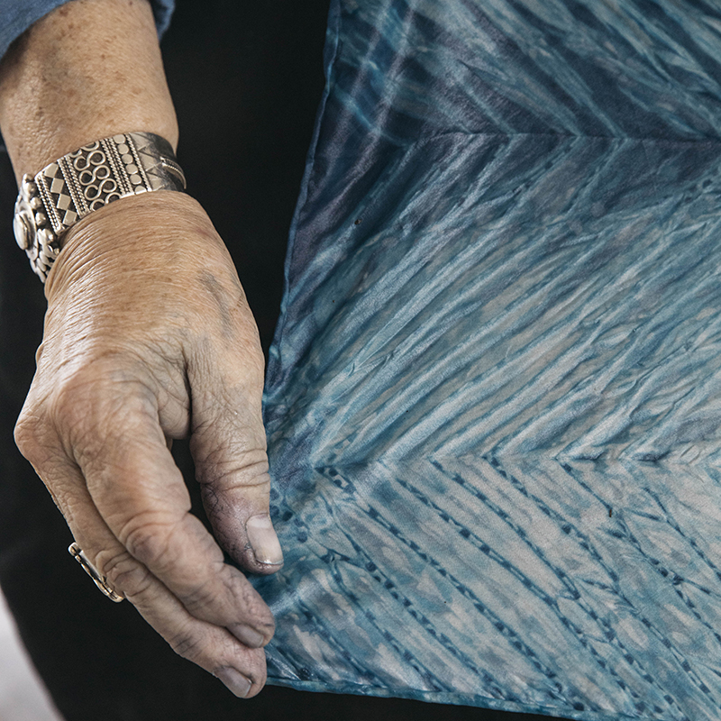 hand showing indigo dyed cloth